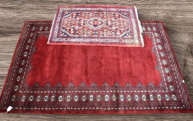 A mid 20th Century deep red hand knotted Pakistani rug...