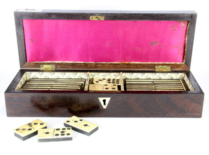 A mother of pearl inlaid and rosewood veneered Edwardian cribbage box containing a set of dominoes, box size. 29 x 9.5 x 6cm.