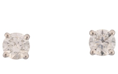 A pair of 18ct white gold 1.01ct solitaire diamond stud earr...