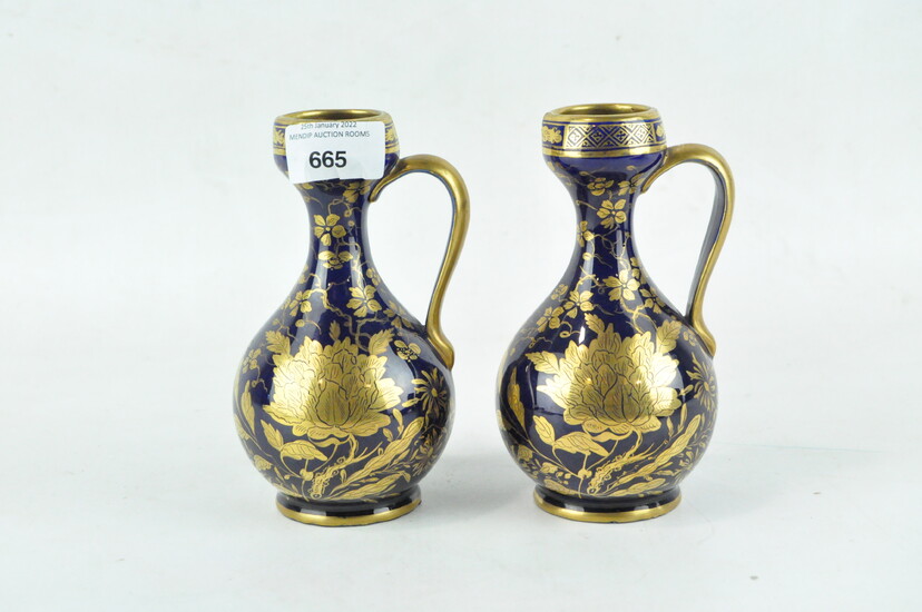 A pair of 19th century Staffordshire glazed ceramic ewers