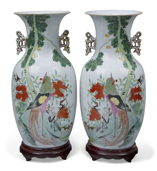 A pair of Chinese famille rose vases, Republic period, decorated with birds and foliage, inscribed to the reverse, with pierced gilt handles, 42cm high, later wood stands (2)