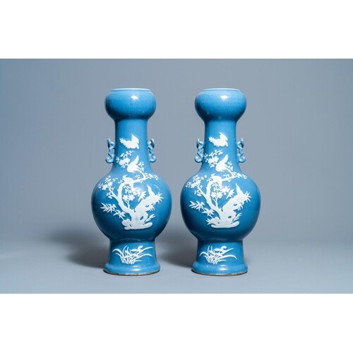 A pair of Chinese white slip-decorated blue-ground vases, 19...
