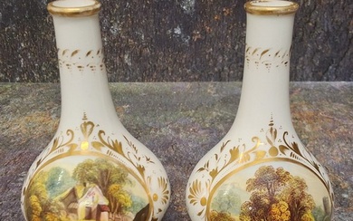 A pair of Derby bottle vases, decorated in the manner of Dan...