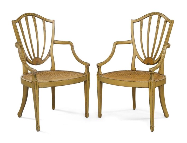A pair of George III painted caned elbow chairs, circa 1790, the shield shape back rests hand painted with flowers and fan, raised on square tapered legs to spade feet Provenance: original receipt from Ayer & co (antique) LTD, dated 1958