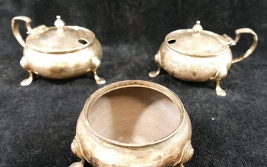 A pair of George V silver circular mustard pots, raised on h...