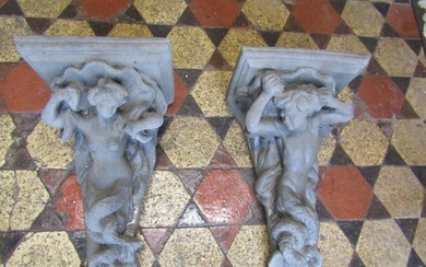 A pair of cast composition stone corbels with mermaid and me...