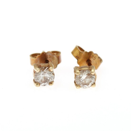 A pair of diamond solitaire ear studs each set with a brilliant-cut diamond, totalling app. 0.60 ct., mounted in 14k gold. (2)