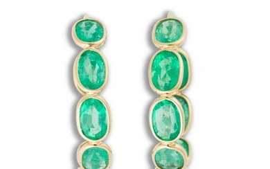 A pair of emerald and eighteen karat gold hoop earrings
