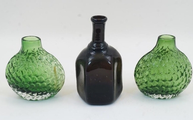 A pair of moulded green glass ‘fish scale’ vases, 20th century, 14cm high; together with a blown hexagonal glass bottle, 18cm high (3)