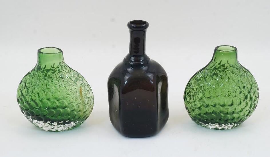 A pair of moulded green glass ‘fish scale’ vases, 20th century, 14cm high; together with a blown hexagonal glass bottle, 18cm high (3)