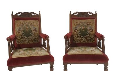 A pair of red velvet covered armchairs