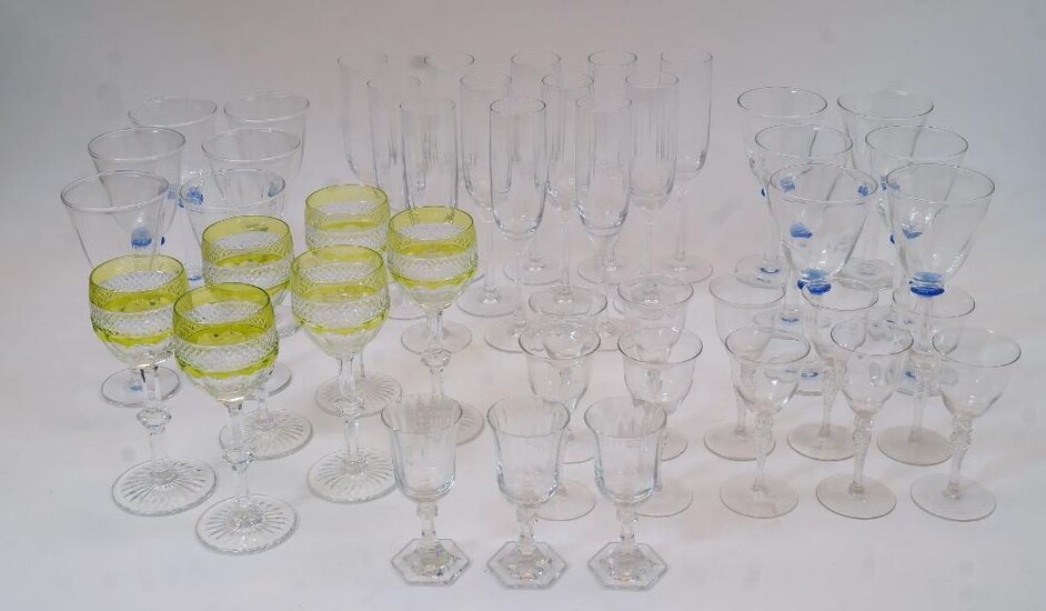A quantity of drinking glasses, 20th century clear and coloured glass, to include: a set of six St Louis crystal wine goblets in the 'Harlequin' pattern, acid green and clear glass, 18cm high; a set of twelve wine glasses with blue glass knopps...