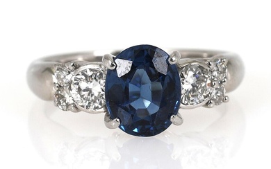 A sapphire and diamond ring set with oval-cut sapphire weighing app. 1.59...