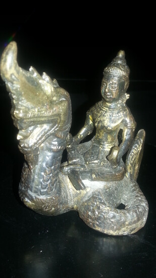 A small early gilt bronze figure of buddha seated...