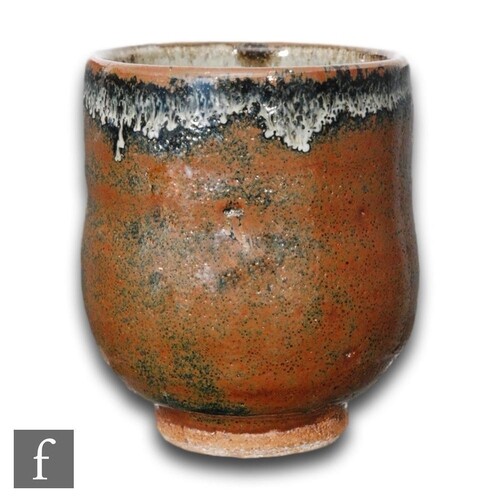 A small hand thrown Yunomi beaker of footed circular form, f...