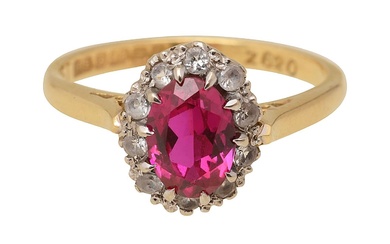 A synthetic ruby and white stone ring