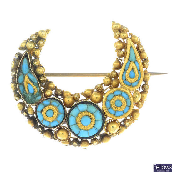 A turquoise crescent brooch.