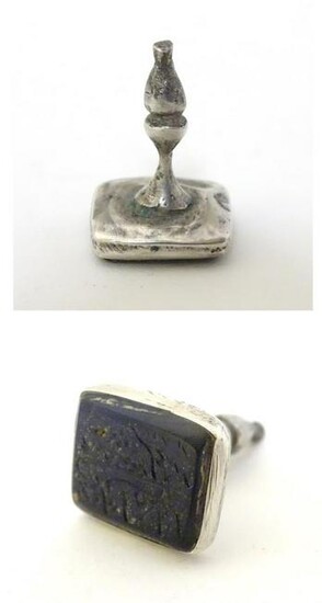 A white metal fob seal with hard stone seal under