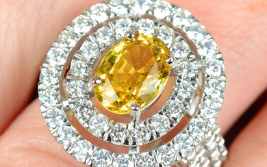 A yellow sapphire and brilliant-cut diamond cluster ring.