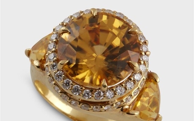 A yellow zircon, diamond, and eighteen karat gold ring...