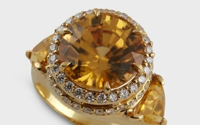 A yellow zircon, diamond, and eighteen karat gold ring