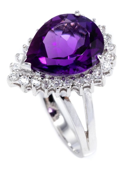 AN 18CT WHITE GOLD AMETHYST AND DIAMOND RING; pear cut amethyst of approx. 3.7ct within a border of 24 round brilliant cut diamonds...