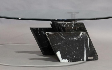 An Artedi coffee table, circular glass top raised on black marble base, 33cm high, 102cm diameter