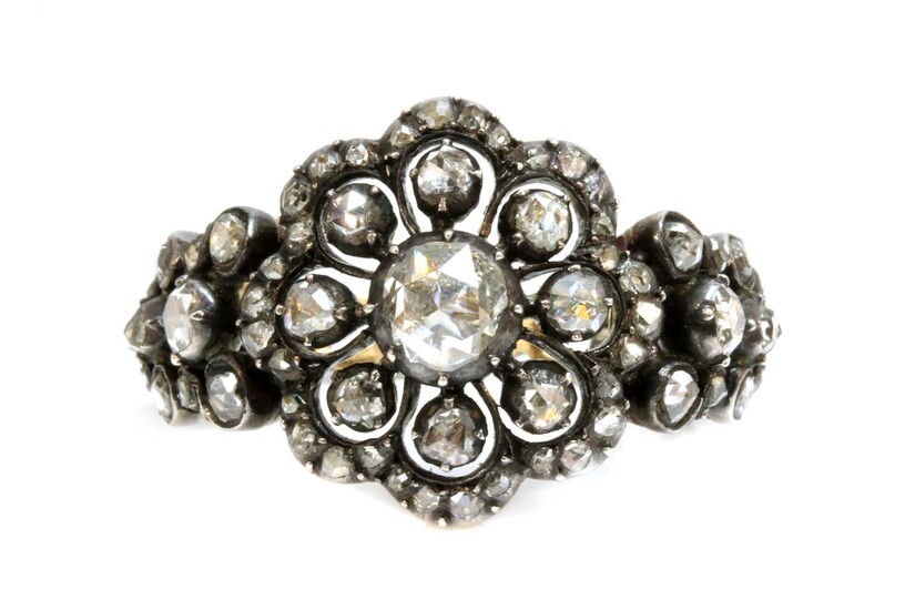 An antique-style diamond set daisy cluster ring
