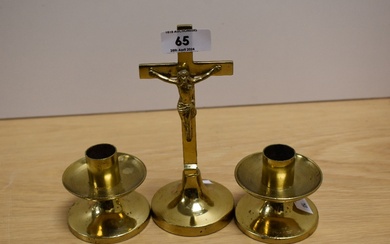 An early 20th Century brass altar set, comprising crucifix and two candles, the crucifix measures