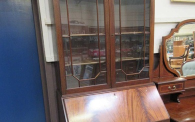 An early 20th century flame mahogany bureau bookcase having a...