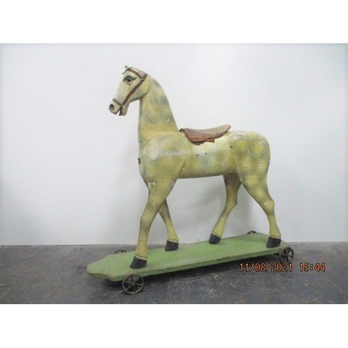 Antique Victorian pull along wooden horse with cast iron whe...