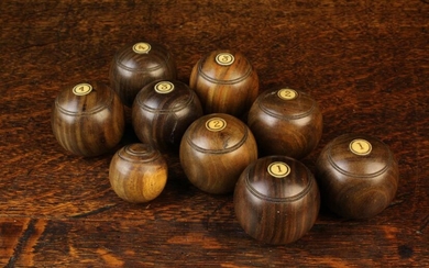 Eight Turned Lignum Carpet Bowls in two sets numbered with 1 - 4 and an accompanying jack. The bowls