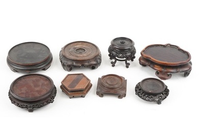 Eight antique Chinese carved hardwood stands, some possibly ...