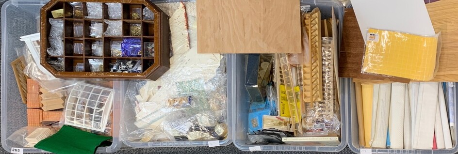 Four boxes containing dolls house building items, including bricks, wall paper, wooden items, staircases, window bays, etc.