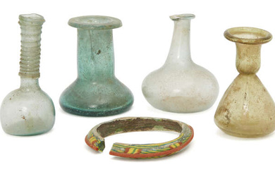 Four small Roman glass vessels and a bangle circa 2nd-4th century AD....