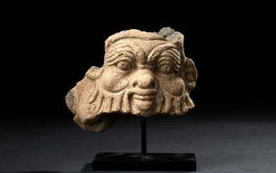 Fragmentary relief representing the mask of the god Bes.