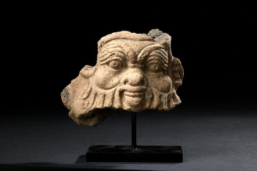 Fragmentary relief representing the mask of the god Bes.