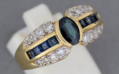 Gold ring set with a sapphire shouldered with calibrated sapphires...