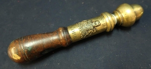 Heavy brass tipstaff with turned wood handle (cracked), with...