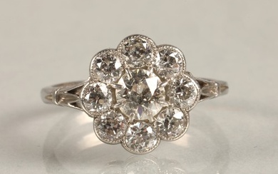 Ladies Diamond daisy cluster ring set in white metal, centra...