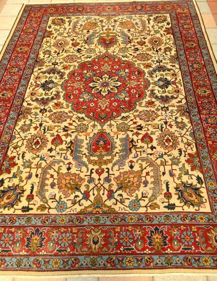 Large and rather thin Tabriz ( North West of Iran ). Middle XX°. Technical characteristics velvet made of quality lambswool on a cotton foundation. Beautiful polychromy. Beige field with garlands of geometrically multicoloured stylised palmette...