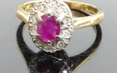 Lot details An 18ct gold, ruby and diamond oval cluster...
