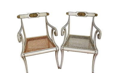 Pair of Regency style white painted and parcel gilt open elbow chairs with cane seats on sabre legs