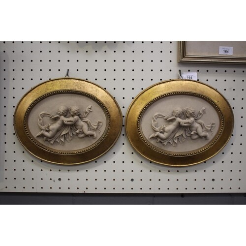 Pair of cast composite angels plaques, well framed, each app...