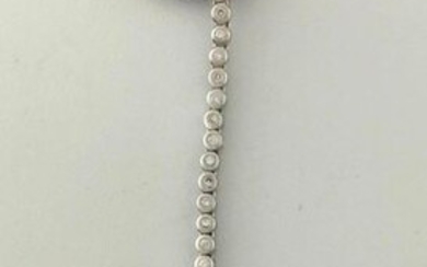 Pendant in white gold 750°/°°° and its silk cord set with a diamond holding a chocolate-coloured cultured pearl in pendants, Gross weight: 6,3g