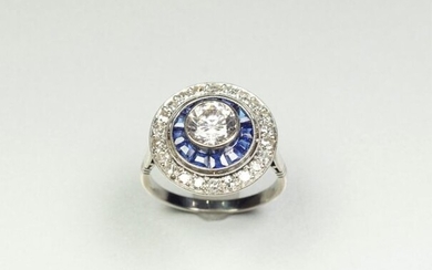 Platinum ring (850/oo), the round plate centered with a white...