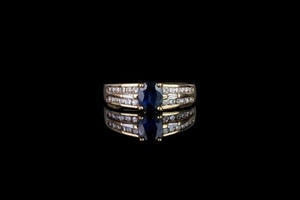 Sapphire and diamond ring, 1 sapphire in the centre, 4 claw set, 2 baguette cut diamonds either side, a total of 24 diamonds...