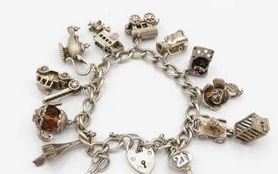 Silver charm bracelet with assorted charms - some articulate...