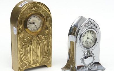 TWO METAL CASED MANTEL ALARM CLOCKS, ONE IN THE ART NOUVEAU STYLE WITH A BRASS CASE EMBOSSED WITH LILIES, THE OTHER IN THE EDWARDIAN...