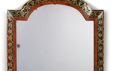 Table mirror in brass and pewter marquetry on a red and brown tortoiseshell background, the curved pediment, the border decorated with friezes of interlacing and leafy bases, against a border with double brass fillets. (Restorations and small accidents).